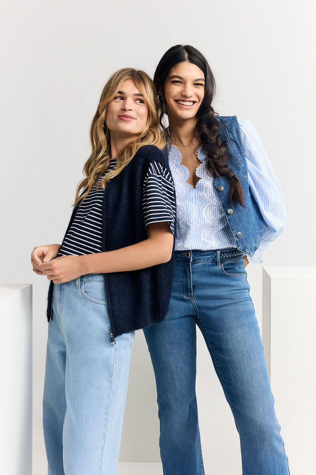 2 models smiling and posing with the new collection